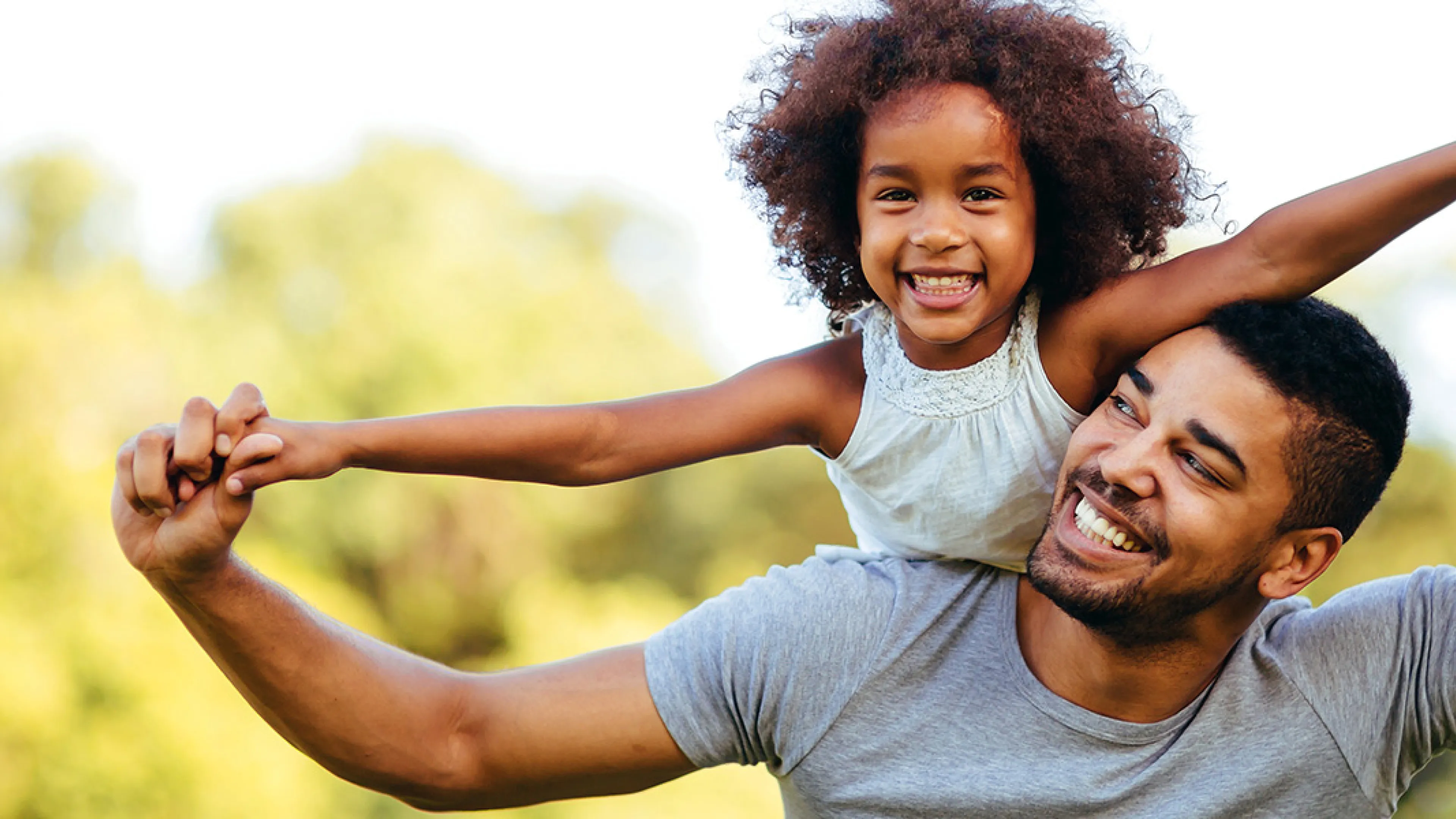 Father and daughter holding hands and smiling