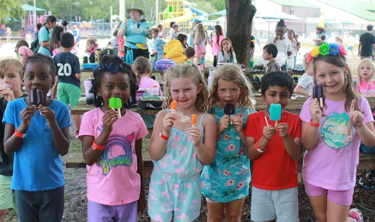 Campers enjoying popsicles at Camp Cristina YMCA.