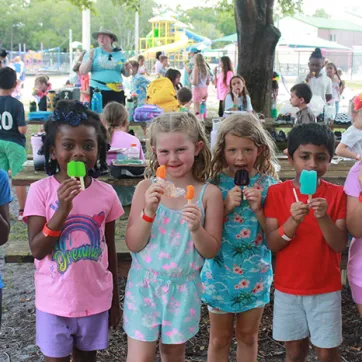 Campers enjoying popsicles at Camp Cristina YMCA.