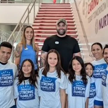 MSgt Rosmell MejiaEscobar, USMC, first from left and Major Araceli  Macias can be seen second from right - with their families.